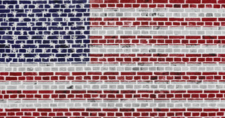 Close-up on a brick wall with the flag of the USA painted on it.の写真素材