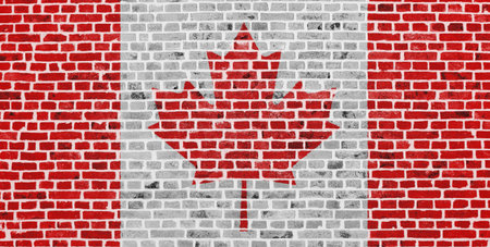 Close-up on a brick wall with the flag of Canada painted on it.の写真素材