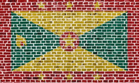Close-up on a brick wall with the flag of Grenada painted on it.の写真素材