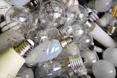 Lamorlaye, France - April 01 2022: Recycling bin filled to the top with bulb lamps.のeditorial素材