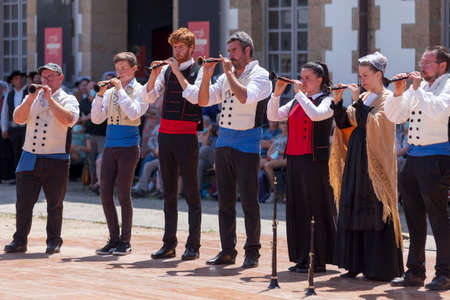 Morlaix, France - July 18 2021: Group of Breton musicians in traditional costumes playing bombards.のeditorial素材