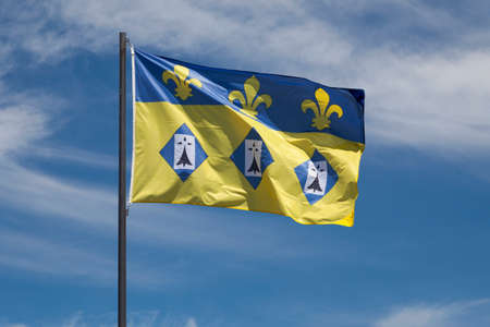 Flag of the city of Dol de Bretagne waving un mid air.の写真素材