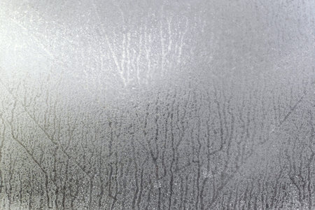 Window of a car completely covered in ice after the morning frost.