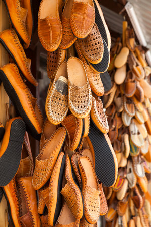 Stack of Opanci for sale on a market stall on Skopje, North Macedonia. Opanci are traditional peasant shoes worn in Southeastern Europe (specifically Bosnia and Herzegovina, Bulgaria, Croatia, Macedonia, Serbia, and also Romania and Albania).の写真素材