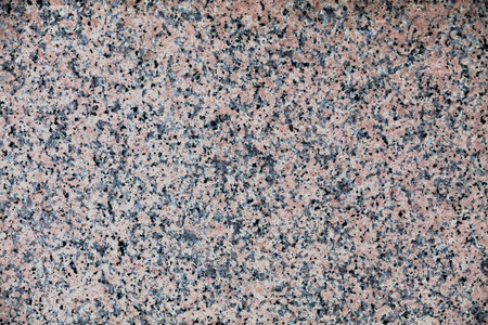Full frame close up on a pink granite slate.