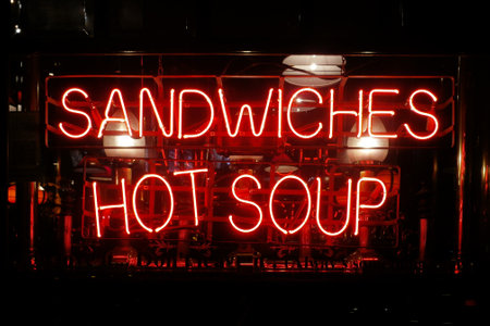 Close-up on a neon light shaped into the short phrase "Sandwiches, Hot soup".の写真素材