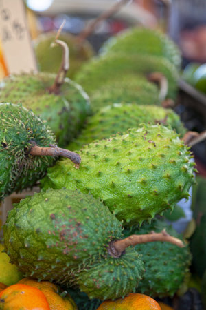 Close-up on a stack of soursops for sale on a market stall