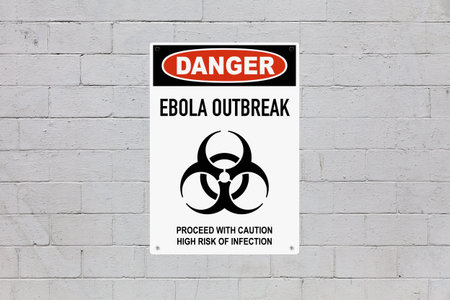 Black, red and white danger sign attached on a brick wall painted in grey. The sign stating...