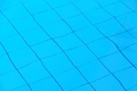 Close-up on the swimming pool tiles under the water.の写真素材