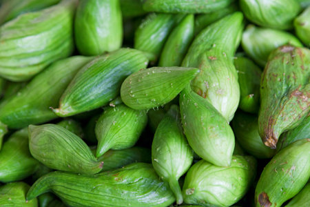 Close-up on a stack of stuffing cucumbers (Cyclanthera pedata) for sale on a market stall.の写真素材