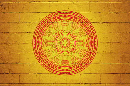 Flag of the Dharmacakra painted on a cinder block wall.の写真素材