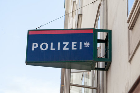 Vienna, Austria - June 18 2018: Police sign atop the entrance of a police station in Vienna with written "Polizei" next to the Austrian coat of arms.のeditorial素材