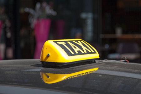 Close-up on a yellow Austrian taxi sign from Vienna.の写真素材
