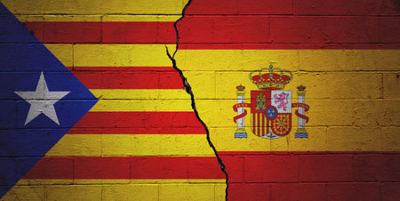 Cracked cinder block wall painted with a Catalonian flag on the left and a Spanish flag on the right.の写真素材