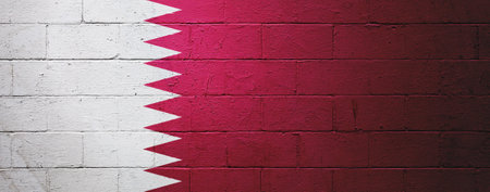 Flag of Qatar painted on a cinder block wall.の写真素材