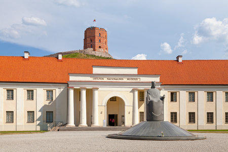 Vilnius, Lithuania - April 12 2019: The statue of King Mindaugas of Lithuania in front of the entrance of the National Museum with Gediminas Tower in background.のeditorial素材