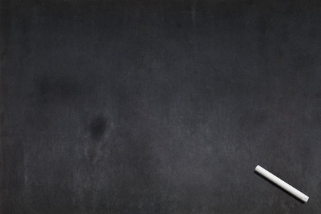 Blank blackboard with a white chalk on the right bottom corner.の写真素材