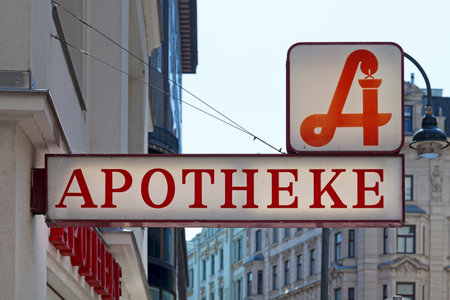 Austrian pharmacy displaying the traditional pharmacy sign above a second sign "Apotheke", meaning in English "Pharmacy".の写真素材