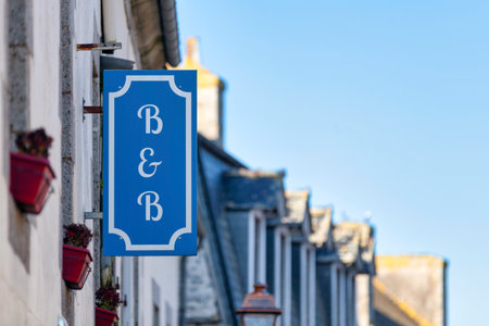 Blue bed and breakfast sign above a building entrance.の写真素材
