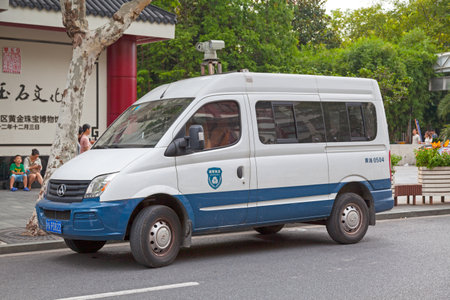 Shanghai, China - August 11 2018: Police van parked in a street outside of YuYuan Market.のeditorial素材