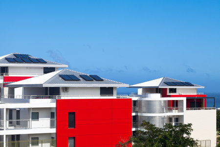 Modern condominiums of a sea resort with solar panels on their roofs.の写真素材