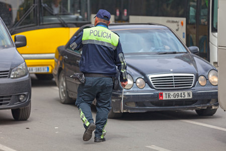 Tirana, Albania - April 23 2019: Road policeman (Policia Rrugore) doing the traffic.のeditorial素材