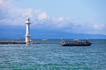 Geneva, Switzerland - June 11 2018: Tourist boat passing by the Phare des PÃ¢quis.のeditorial素材
