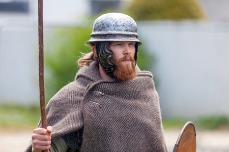 Carhaix, France - May 01 2023: Warrior with his spire, shield and helmet reenacting a battle between Gaulish tribes.のeditorial素材