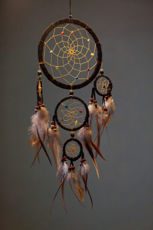 Close-up on a Dreamcatcher hanging in a dark room.の写真素材