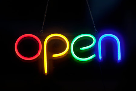Close-up on a neon light shaped into the word "open".の写真素材