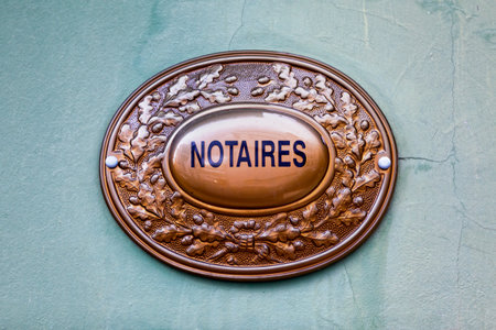 Outdoor sign indicating that a Notaire (french for notary) is practicing inside the building.の写真素材
