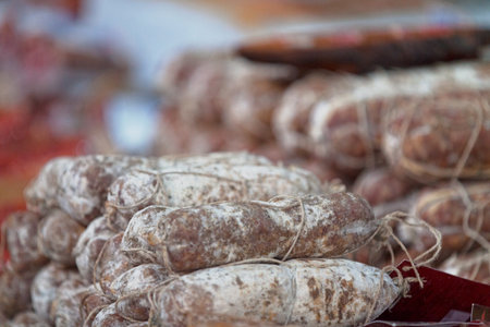 Stack of sausages "Salame crÃ¼" for sale on a market stall in Zurich.の写真素材