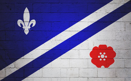 Flag of the Franco-Albertans painted on a cinder block wall.の写真素材