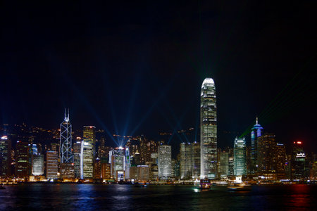 Hong Kong, China - August 17 2007: Victoria Harbour with the skyscrappers from Hong Kong Island illuminating the night.のeditorial素材