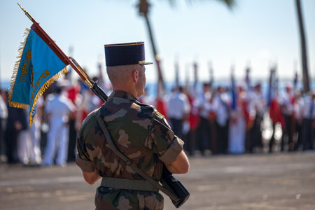 Saint-Paul, La RÃ©union - June 28 2017: French soldier holding the flag of his regiment (Compagnie d'Instruction) during a monthly ceremony of the RSMA (RÃ©giment de Service Militaire AdaptÃ©e) rewarding the young soldiers. His flag meaning he is one of tのeditorial素材