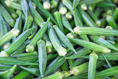 Close-up on a stack of okras for sale on a market stall.の写真素材