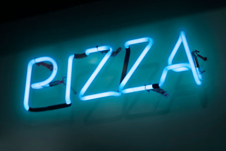 Cyan neon light shaped into the word "pizza".の写真素材