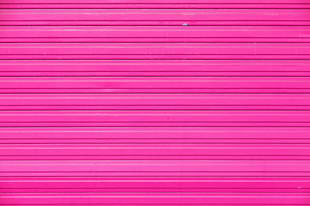 Full frame close-up on a pink iron shutter.の写真素材