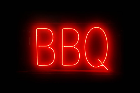 Close-up on a red neon light shaped into the word "BBQ".の写真素材