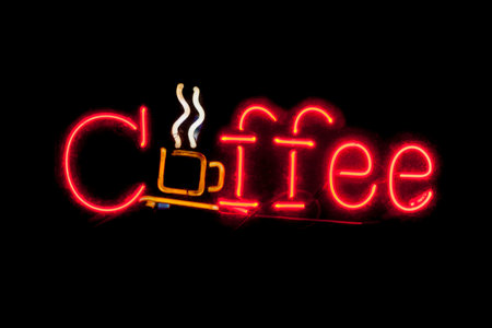 Close-up on a neon light shaped into the word "Coffee".の写真素材