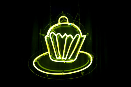 Close-up on a yellow neon shaped into a cupcake.の写真素材