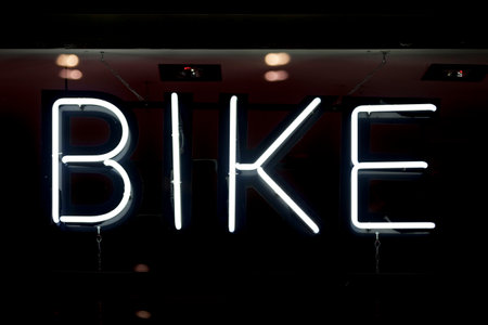 Close-up on a white neon light shaped into the word "bike".の写真素材