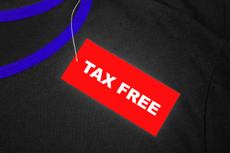 Red tag on a grey and blue t-shirt with Tax free written in white.