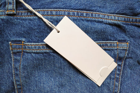Close-up on a blank price tag at the back of a jean.の写真素材