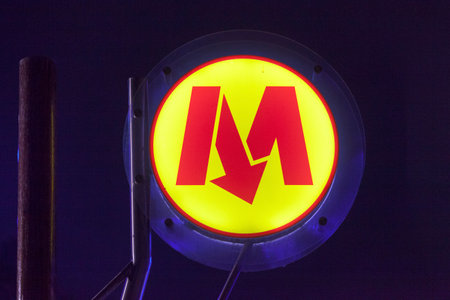 Warsaw, Poland - June 08 2019: Close-up on an illuminated sign of the Warsaw Metro (Polish: Metro Warszawskie) at night.のeditorial素材