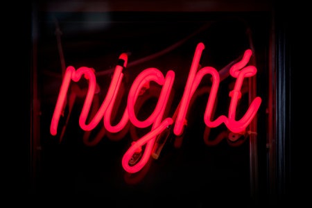Red neon light shaped into the word "Night".の写真素材