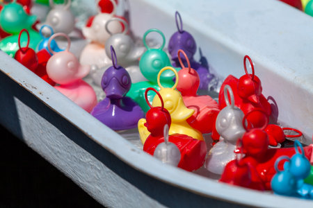 Colorful plastic ducks in the water basin of a traveling carnival stall.の写真素材