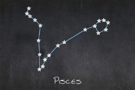 Blackboard with the Pisces constellation drawn in the middle.の写真素材