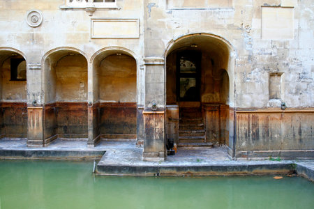 View of the green waters of the Roman baths of Bath.