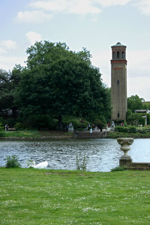 London, England - May 19 2007: People walking around the Water Tower near the pond in Kew Gardens in London.のeditorial素材